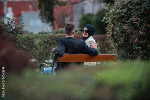 Young happy Muslim couple enjoying romantic time in park. photo