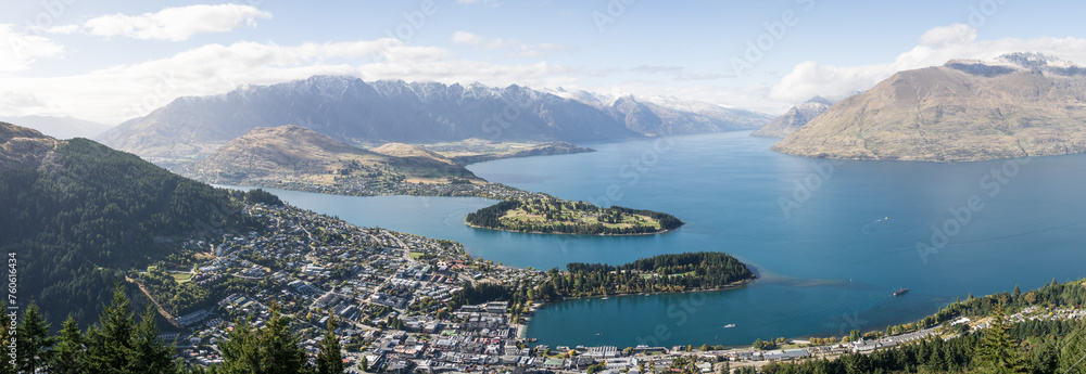Wide panoramic view on mountain town on a lake shore surrounded by beautiful mountains, New Zealand