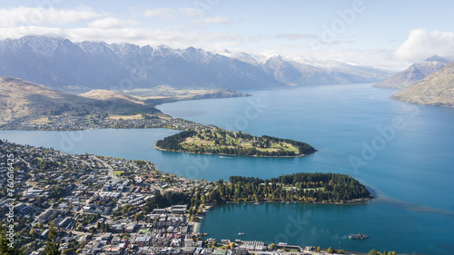 View on busy mountain town located on a lake shore surrounded by beautiful mountains, New Zealand