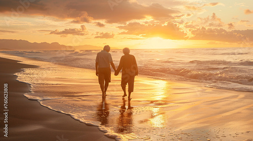 Elderly couple enjoying a serene walk hand in hand on the beach at sunset, capturing a moment of peace and lifelong love in golden hour. Rear view of an elderly couple walking together on the beach.