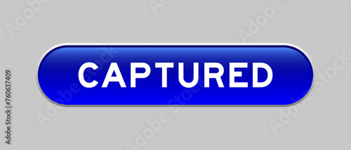 Blue color capsule shape button with word captured on gray background