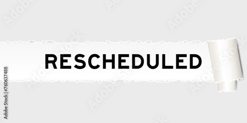 Ripped gray paper background that have word rescheduled under torn part