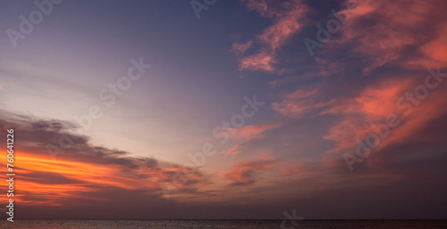 Dusk sky over sea in the evening on twilight sky clouds with orange sunlight, Horizon sea sky landscape background 