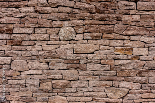 Antique Handmade stone brick wall. Brown red orange color.