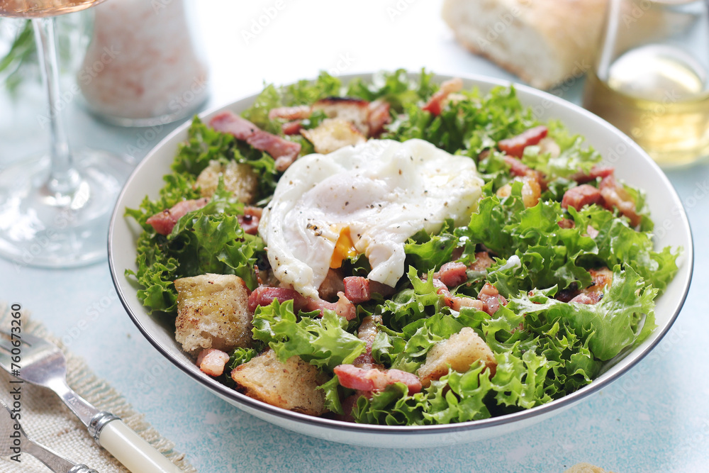 A bowl with salad lyonnaise served for lunch	