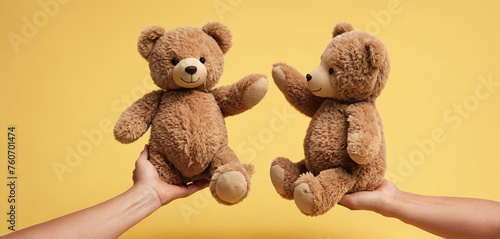 Two hands touching or holding from different sides plush toy to represent parental care and custody
