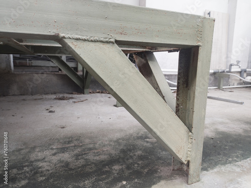 Iron frame stand for water tank storage.