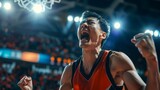 Asian basketball player celebrates victory, unleashing shouts of joy against the backdrop of a basketball stadium. Emotional celebration of winning the game