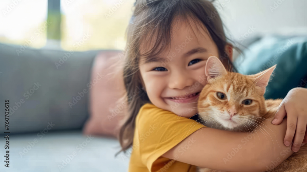 Little happy girl tenderly hugs her cat tightly in a bright spacious living room. Friendship concept between humans and animals Little happy girl tenderly hugs her cat tightly in a bright spacious living room. Friendship concept between humans and animals