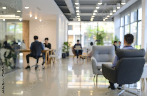 Blurred business office with people in casual wear, blurred bokeh background.