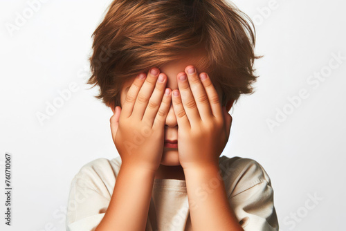 little boy closes his eyes and covers with both hands isolated on white solid background. ai generative