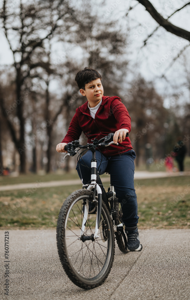 A young boy rides his bicycle through a city park, exemplifying healthy, active outdoor living and the freedom of youth. A young boy rides his bicycle through a city park, exemplifying healthy, active outdoor living and the freedom of youth.