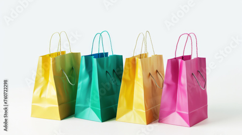 A lineup of brightly colored shopping bags with cord handles stands against a white background, representing a variety of purchases or gifts.