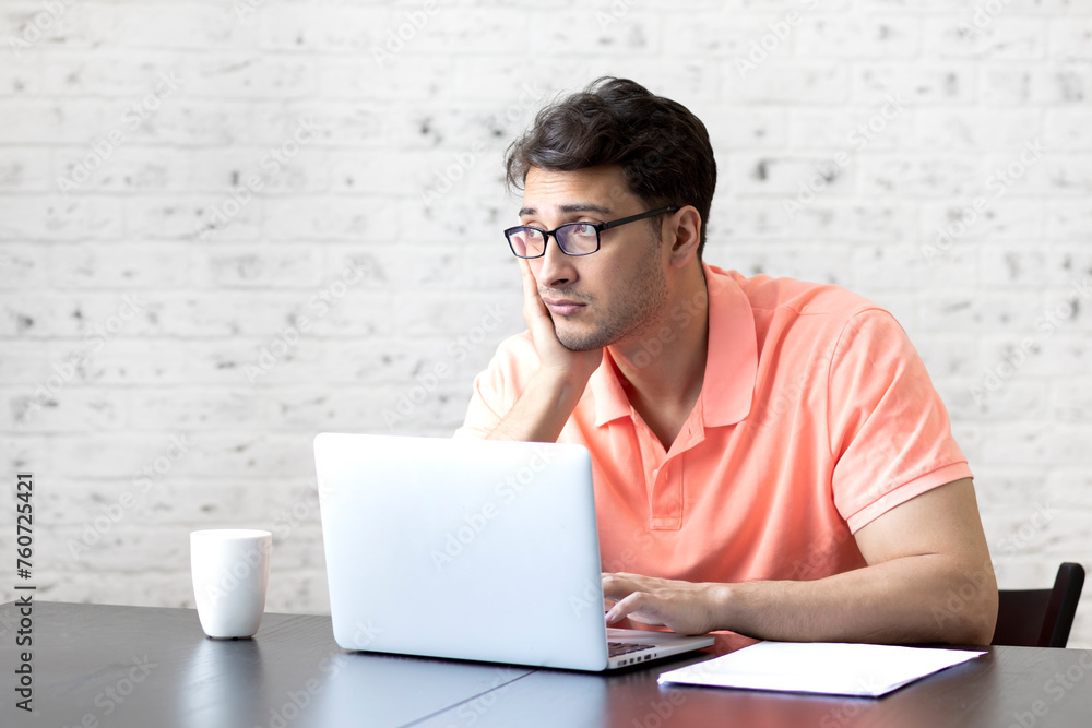 Stressed man working on laptop at home. Distance work concept Stressed man working on laptop at home. Distance work concept