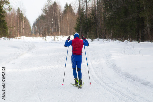 People ski in winter on a ski track through a winter forest.Cross Country skiing. © Александр Поташев