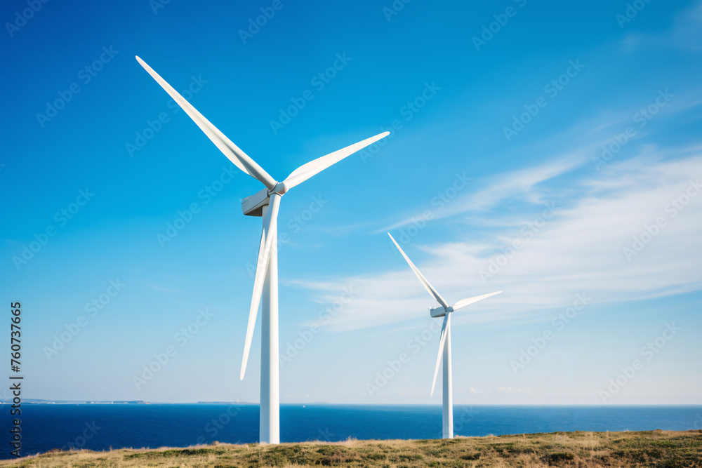 Two wind turbines are standing on the shore, renewable energy and sustainability concept