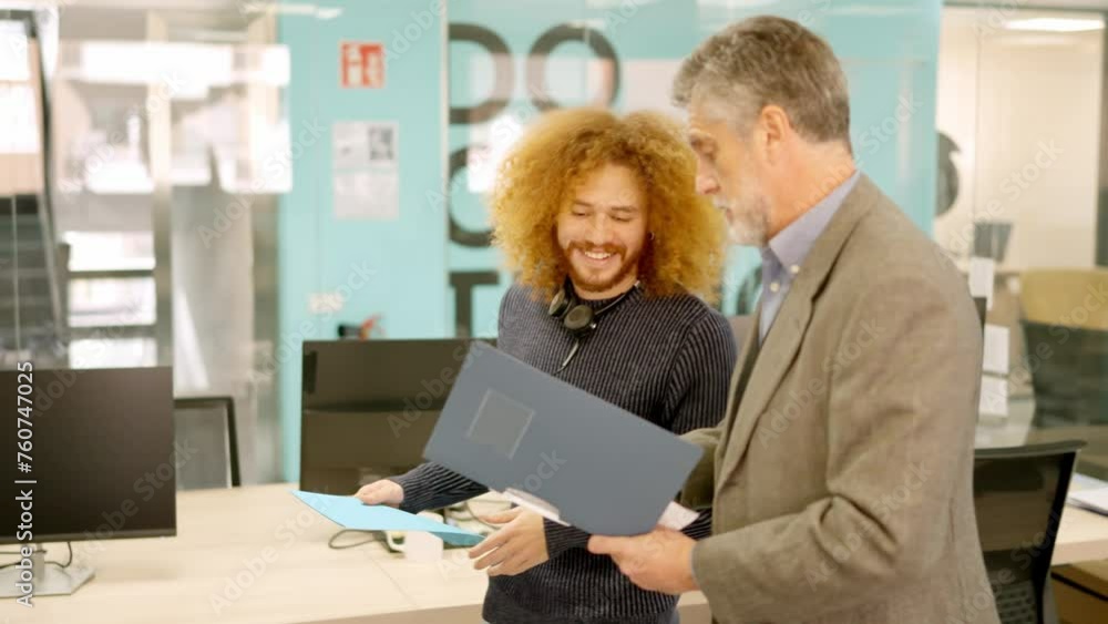 Manager and employee talking about informs in a coworking Manager and employee talking about informs in a coworking