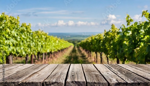 empty wooden boards weathered planks table top with blur background of vineyard at sunny summer day