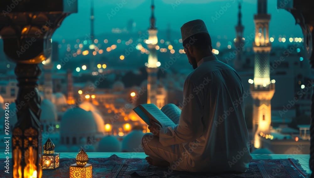 A man is reading the Quran with an open window overlooking Ramadan lights and a mosque.