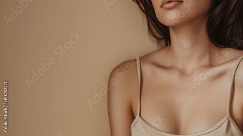 Sensitive female body on a beige background. Women's neck and shoulders