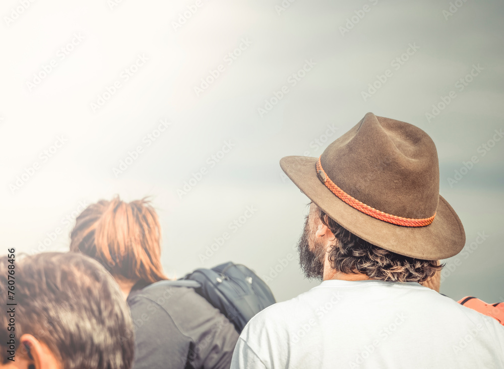 Back view picture of a man wearing a elegant sun hat.