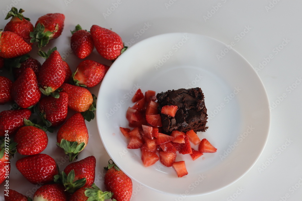 Chocolate brownies. Indulge in decadent chocolate brownies paired with fresh strawberries Chocolate brownies. Indulge in decadent chocolate brownies paired with fresh strawberries