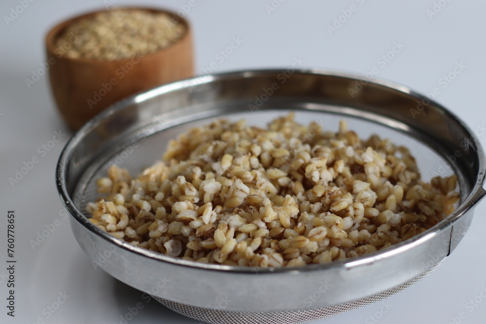 Soaked whole grain hulled barley in the strainer. Soaked whole grain hulled barley in the strainer.