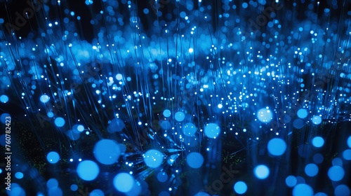 blue fiber optic strands, their illumination creating a mesmerizing blur of light against the contrasting darkness