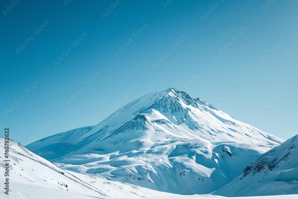 A snow-covered mountain peak under a clear blue sky Perfect for ski resort promotions Outdoor gear advertisements Or inspirational travel blogs.