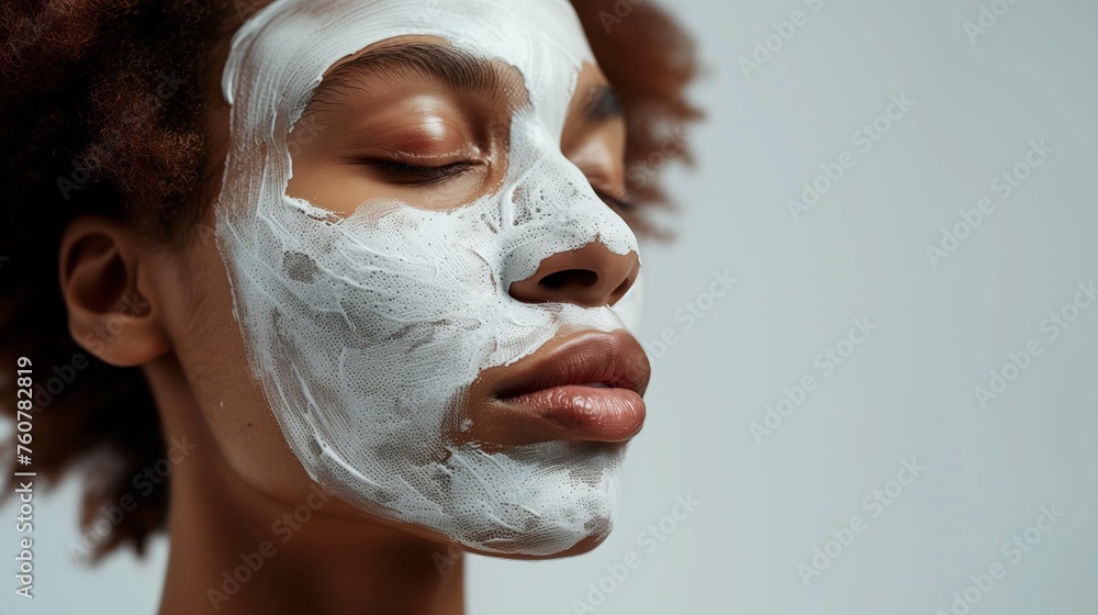 The face with a white facial mask covering half the skin. The model has natural makeup with closed eyes. Generated by artificial intelligence. The face with a white facial mask covering half the skin. The model has natural makeup with closed eyes. Generated by artificial intelligence.