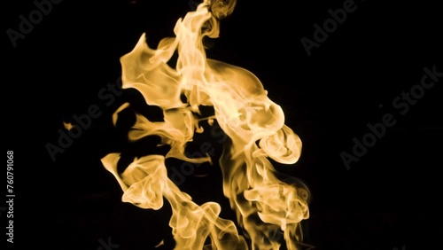 Slow-motion video of fire and flames.A fire pit, burning gas or gasoline burns with fire and flames.Flames and burning sparks close-up,fire patterns.A hellish glow of fire in the dark with copy space photo