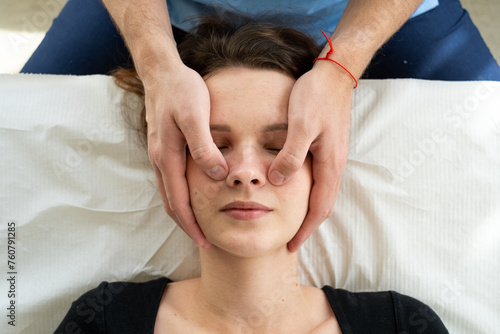 Facial massage, the doctor presses on the points on the face.