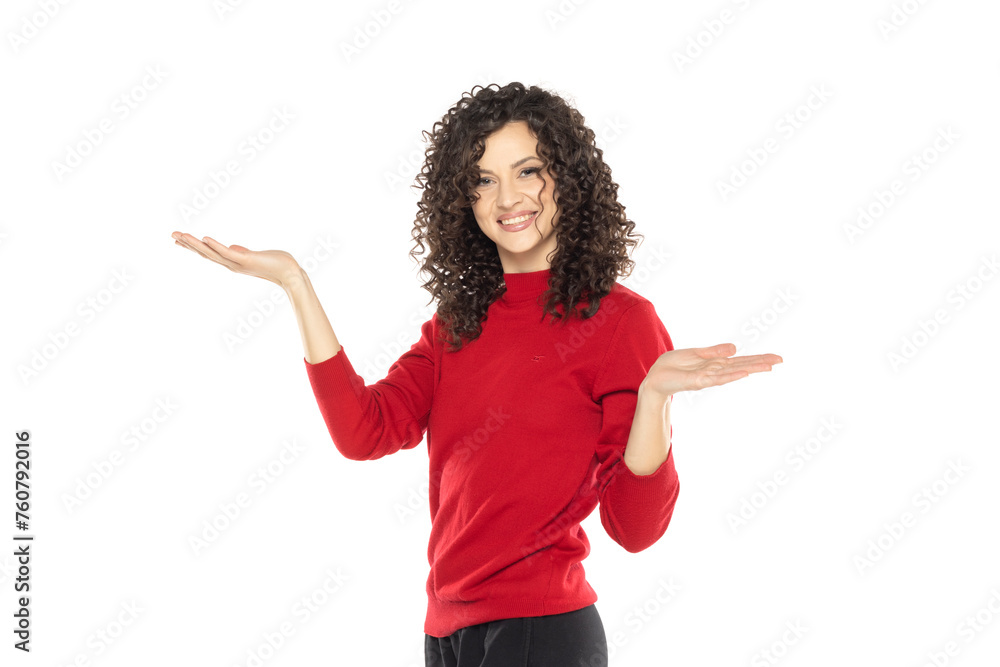 portrait of a young happy curly woman on a white background, advertise some product. portrait of a young happy curly woman on a white background, advertise some product.