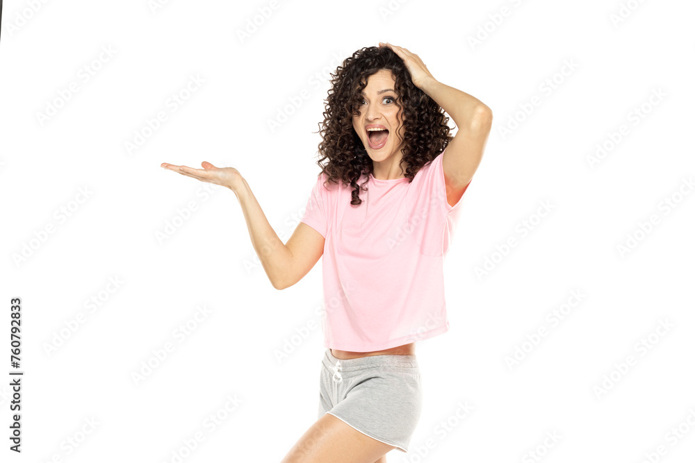 young excited woman posing in shorts and holding imaginary objeect on a white background young excited woman posing in shorts and holding imaginary objeect on a white background