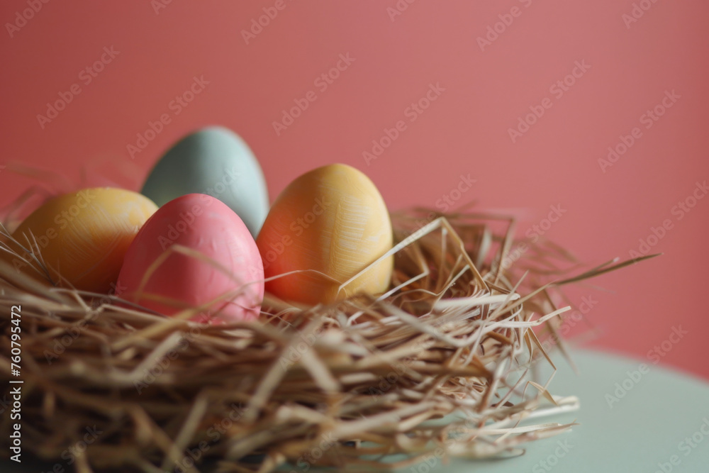 Fototapeta premium Colorful Easter Eggs Nestled in a Pink Background - Festive Easter Atmosphere