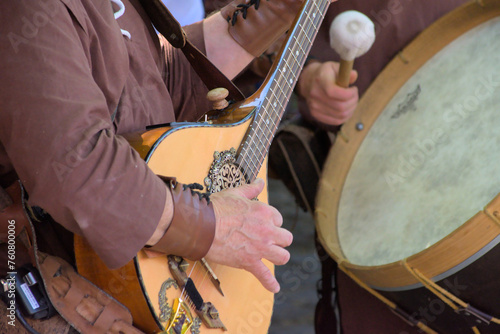 Medieval musician playing a ancient guitar