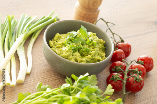 Homemade bowl of guacamole dip with fresh ingredients