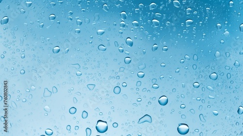 Blue background raindrops on a rain glass 