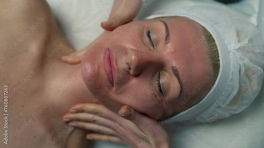 Close-up of the face of a woman receiving a facial massage. Skin preparation for beauty procedures in cosmetology. High quality 4k footage Close-up of the face of a woman receiving a facial massage. Skin preparation for beauty procedures in cosmetology. High quality 4k footage