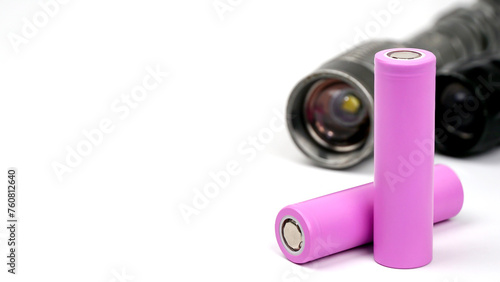 Two pink lithium-ion 18650 batteries , Li-ion 18650 batterie 3.7v Rechargeable use for black flashlight on a white background. Close up with copy space.