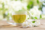 cup of jasmine tea and jasmine flowers