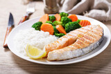 plate of grilled salmon, rice and vegetables