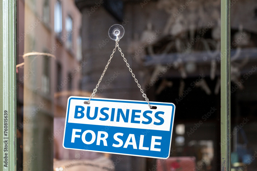 Business for sale sign in a store window
