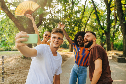 A group of friends celebrating life and taking a selfie together outside. photo