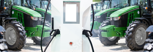 Electric vehicles charging station on a background of agricultural tractors. Concept.