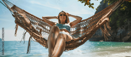 a woman relaxes and enjoys the sun on vacation at the beach in a wicker hammock, Generative AI.