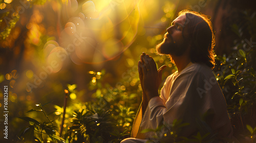 Jesus in intense prayer and supplication before betrayal and crucifix in the garden of Gethsemane, copy space  photo