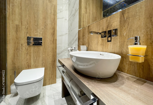 Stylish white table sink in a modern bathroom wooden interior