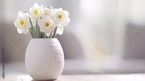 a white vase filled with white flowers sitting on top of a wooden table in front of a curtained window.