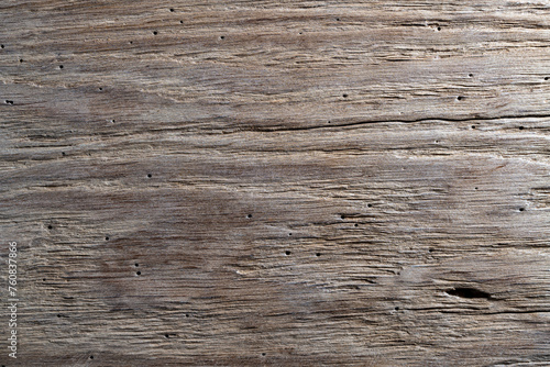 Rustic weathered barn wood background with termites holes. Vintage brown wooden barn oak with cracks and woodgrain. Old wood with nature texture and pattern. Weathered barn timber photo